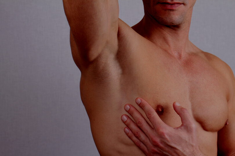 Muscular male torso, chest and armpit hair removal.